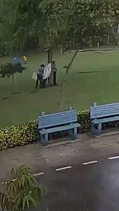 Standing under a tree in the middle of a massive storm