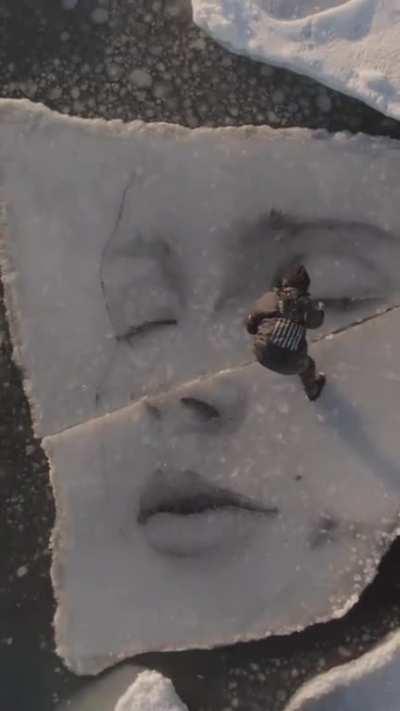 Artist drawing on broken iceberg