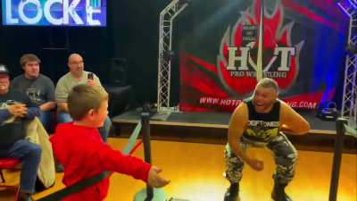 Wrestler terrifies a kid and flips off a baby.
