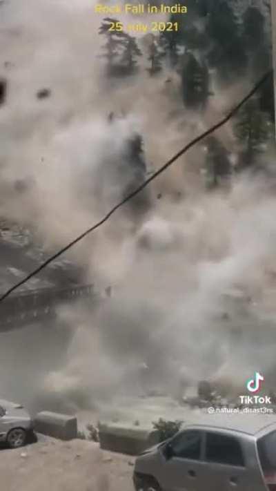 Cameraman captures crazy rockslide and gets to safety in time to see the bridge taken out