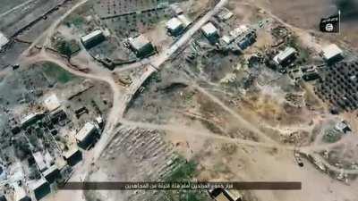 IS fighters have an extremely close quarters gun battle in a town vs pro assad forces.