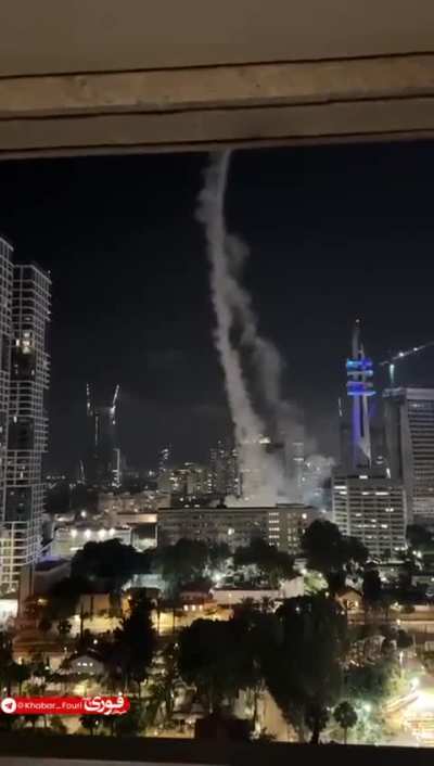 Footage captures Israel’s Defense Ministry headquarters in Tel Aviv attempting to intercept incoming missiles—moments later, the site itself comes under direct attack.