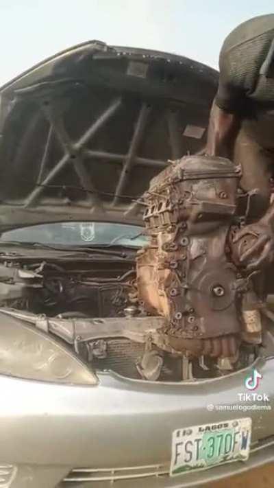 Nigerian Mechanic hoists engine out of a car by himself with no tools.