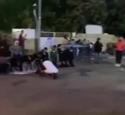 Palestinians praying for the people they have lost, Israelis celebrate infront of them
