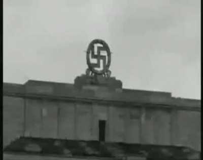 Americans blow up the swastika at the Nuremberg parade grounds.