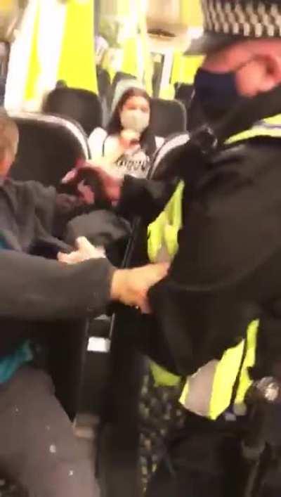 British policeman fights man refusing to wear a mask on a train