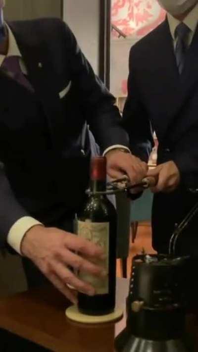 Opening a $15,000 bottle of Petrus, 1961 with heated tools. This method is used to make sure that the cork stays intact.