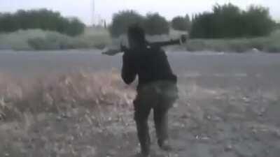 FSA fighter shoots an RPG at SAA tank, and then takes immediate return fire. Deir ez-Zor, Syria. 10-4-2012