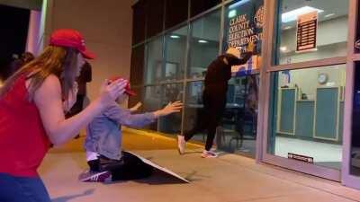 Trump supporters praying in front of a ballot office