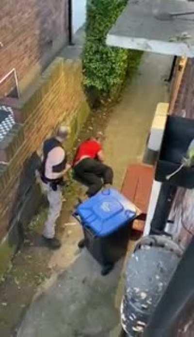 Neighbours fight over Christian cross on gate, ends up with the aggressor knocked out... wife has husbands back on the phone, ride or die.