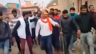 Hindutva group shave the head of a Christian Dalit man, and parade him through the village after having accused him of promoting religious conversions. They 're-convert' him back to Hinduism at a temple while chanting religious slogans and 