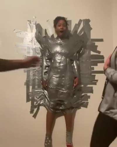 To tape someone to a wall