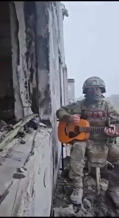 RU POV:Russian soldier sings and plays the guitar somewhere in Ukraine.
