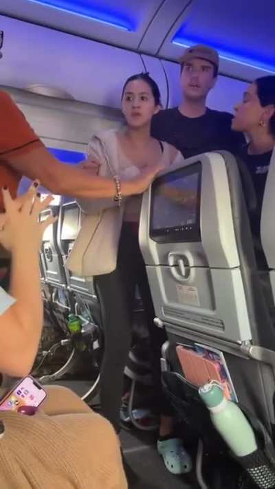 Woman attempts to open emergency exit on plane because her pilot boyfriend told her over the phone that a sound wasn’t normal