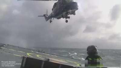 Landing a helicopter on a small ship in rough sea