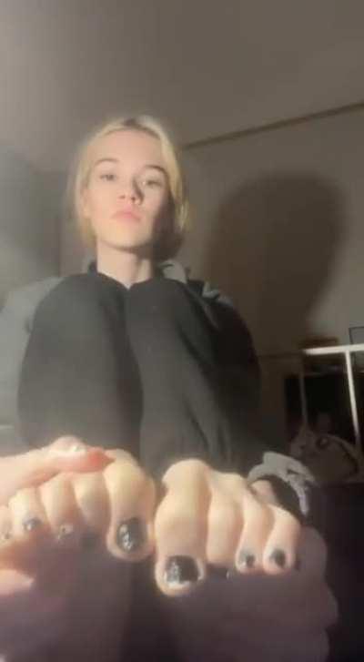 beautiful blonde massages her feet