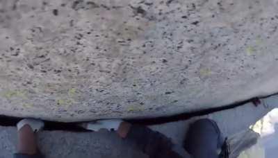 Climber gets uncomfortable on cliff face