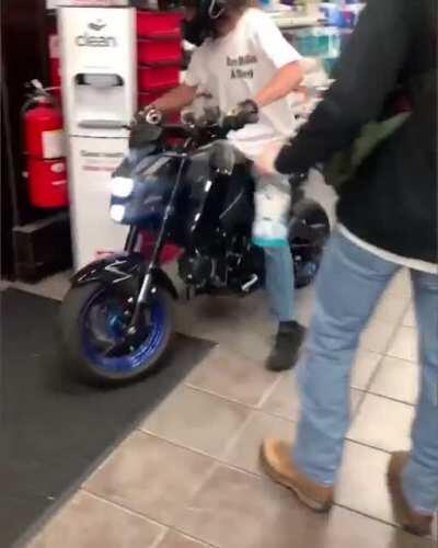 Motorcyclist does a burnout inside a gas station lobby