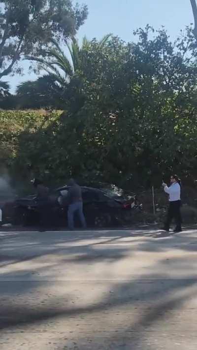 Assailants run car off the freeway in broad daylight in Los Angeles yesterday in brazen robbery