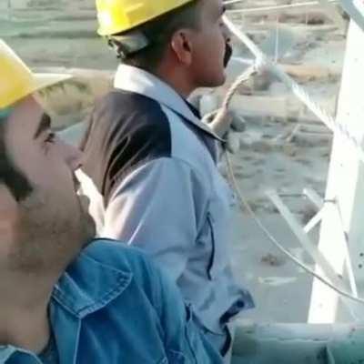 Electrician fires a cigarette from a high-voltage line