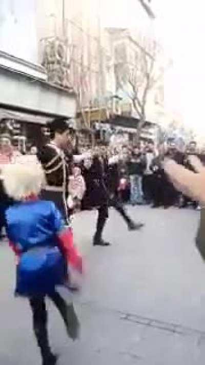A mullah in plainclothes tries to stop three young boys dancing in the middle of Laleh Zar and is heckled by the crowd and sent away
