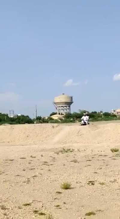 Two village bumpkins stunting on a Royal Enfield