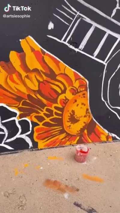 Girl paints mural on building In a day