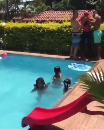 spiderman accidentally waterboards himself, clearly panicking, and the kids...? hey, let's splash water on him. .