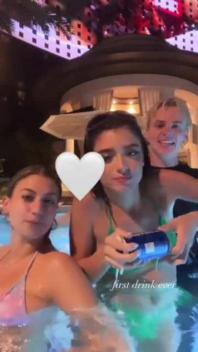 Dixie shotgunning a beer in a bikini