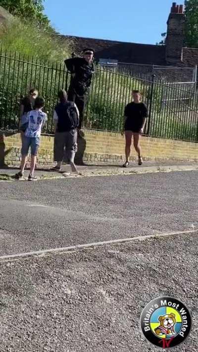 Police officer gets his underwear caught on a fence while chasing suspect