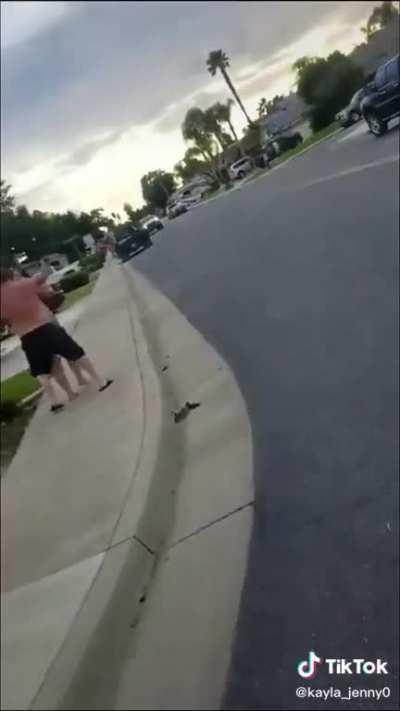 Karen attacks kid for holding a sign (props to her husband)