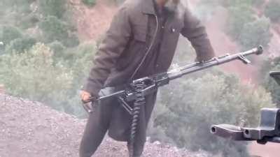 Firing a DSHK (12.7 heavy anti-aircraft machine gun) with his hands