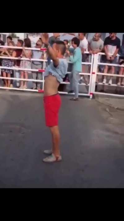 Man wants to stop a running bull using his body to block him