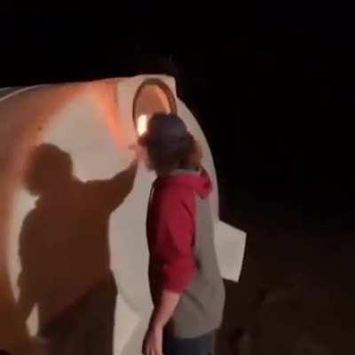 WCGW putting a flaming piece of wood into a mysterious container