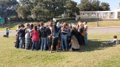 Some of the Qult remains in Dallas one week after JFK Jr failed to return. Today they met back up at the site of JFK Sr's assassination and sang a rendition of 