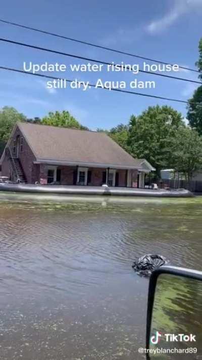 Homeowner uses an Aquadam to protect his home from a flood