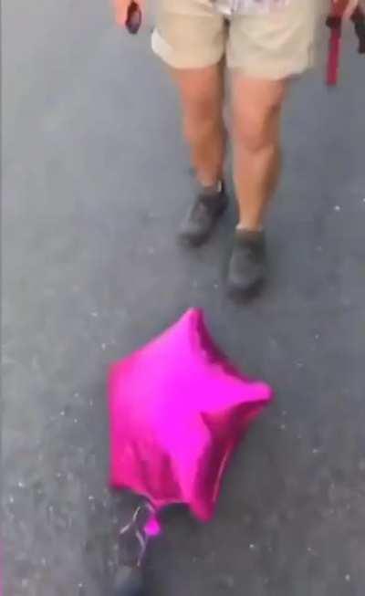 Woman tries to pick on a helpless street balloon....