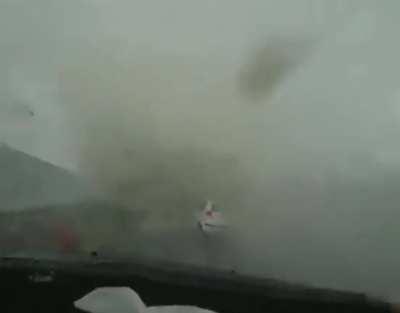 Tornado forms on a car while driving.