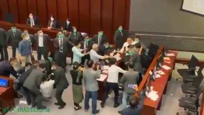 Hong Kong security forcibly removes Democratic council and then unanimously votes pro-Communist as new chairman.