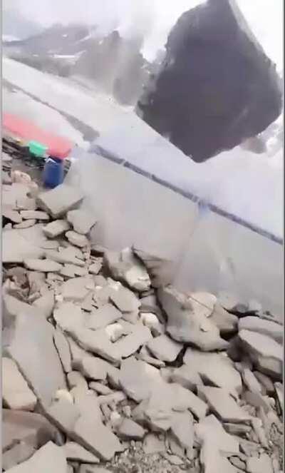 Boulder tumbling down the mountain nearly misses hiker