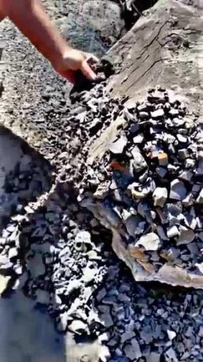 This stone effortlessly crumbling into smaller rocks