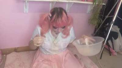Pink haired girl pukes in her bowl