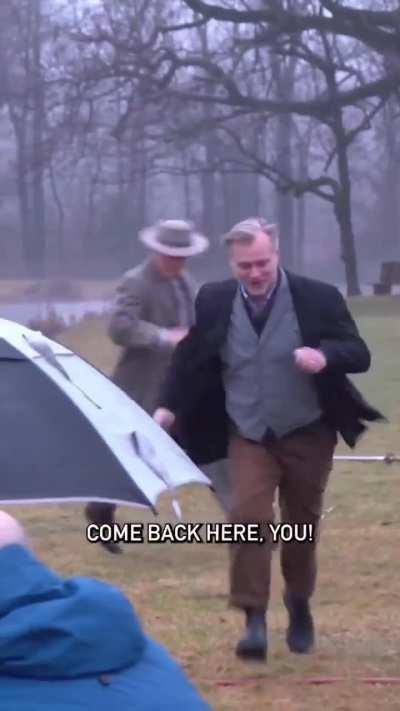 BTS of Nolan running from Stephen Colbert in the OPPENHEIMER gag