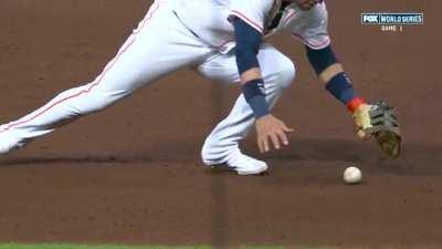 Yuli Gurriel attempts to field a baseball.