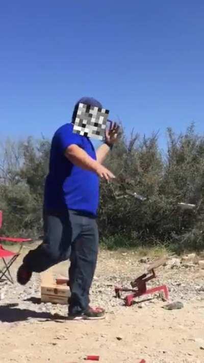 Guy shoots hand while dual-wielding pistols