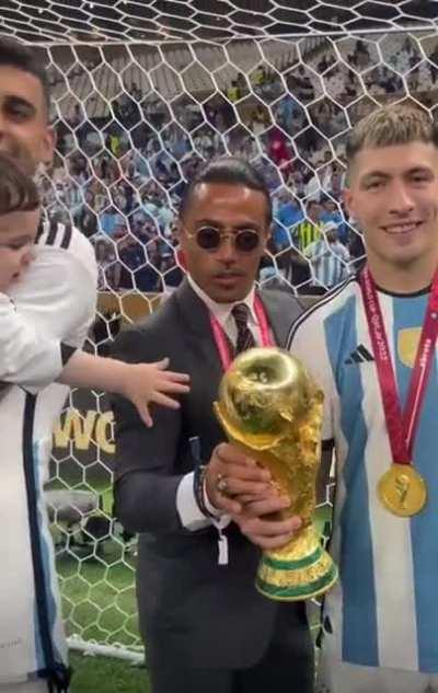 Salt Bae 'salting' the World Cup trophy, while attempting to celebrate Argentina's win with the team
