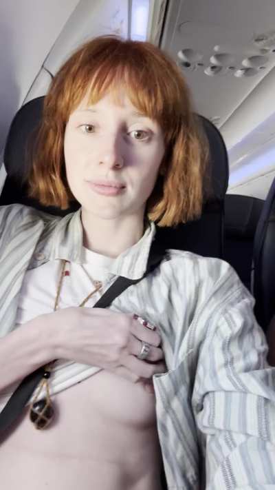 Flashing her tits on a plane