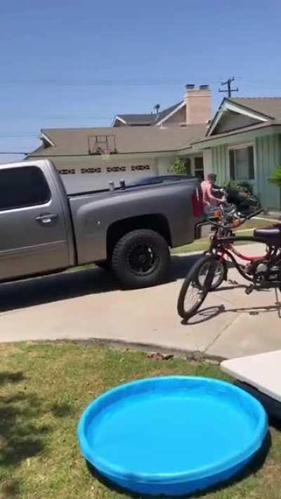 Bike stunt over a kiddie pool........