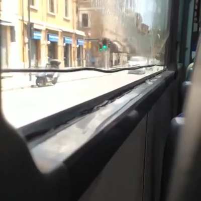 Water trapped in a bus window.