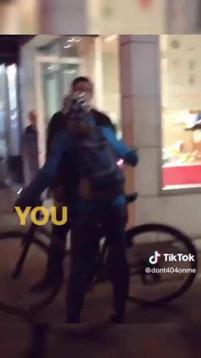 Woman on a bike yelling at a man walking his dog and refusing to let him get by